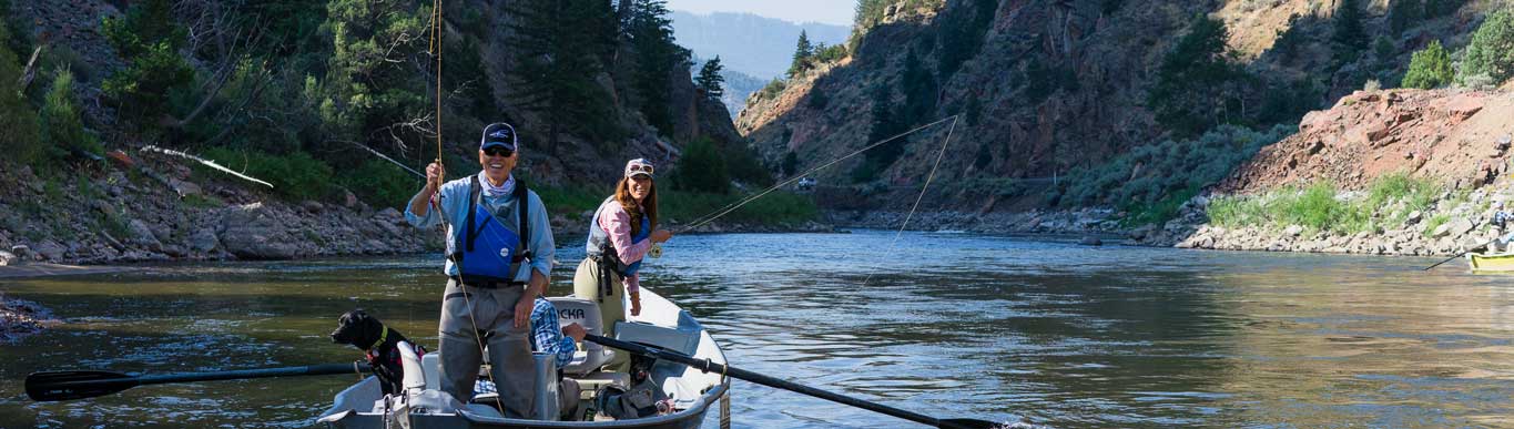 A Vail Valley Anglers guide and client fish from a drift boat in Colorado