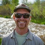 Chase Hansen navigating a whitewater section of the Colorado river during a nice summer day.