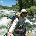 Chase Hansen navigating a whitewater section of the Colorado river during a nice summer day.