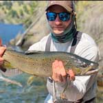 Vail Valley Angles guide Ethan Ledford showcasing a beautiful brown trout caught while fishing in the Vail Valley.