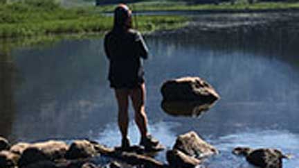 High Country – Female viewing high alpine lake in Vail, CO.